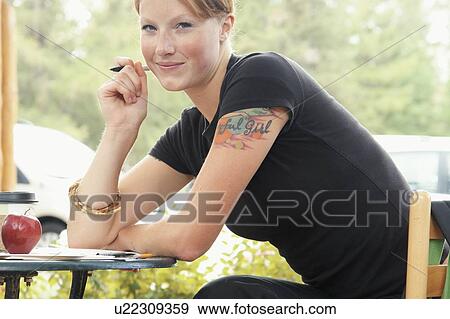 Woman seated at table outdoors, writing, with apple on table, Wasagaming, Riding Mountain National Park, Manitoba, Canada View Large Photo Image Stock Photo - Woman seated at table outdoors, writing, with apple on table, Wasagaming, Riding Mountain National Park, Manitoba, Canada. Fotosearch