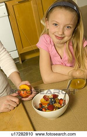 Young girl with healthy fruit and cereal View Large Photo Image Stock Image - Young girl with healthy fruit and cereal. Fotosearch