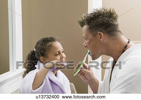 Caucasian dad and Mulatto girl (6 years old) brushing their teeth. View Large Photo Image Stock Image - Caucasian dad and Mulatto girl (6 years old) brushing their teeth.. Fotosearch