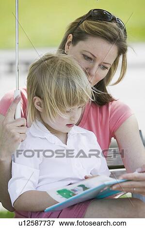 Caucasian Mom and 4 year old Daughter, reading a book on a park bench. Sunset Beach, Vancouver, BC View Large Photo Image Stock Photo - Caucasian Mom and 4 year old Daughter, reading a book on a park bench. Sunset Beach, Vancouver, BC. Fotosearch