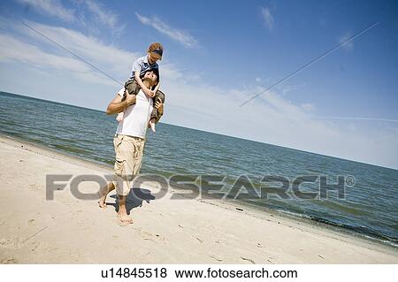 Man carries boy (7) on his shoulders, Grand Beach Provincial Park, Manitoba, Canada View Large Photo Image Stock Photo - Man carries boy (7) on his shoulders, Grand Beach Provincial Park, Manitoba, Canada. Fotosearch