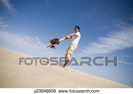 Man swings girl (4) in circle, Grand Beach Provincial Park, Manitoba, Canada View Large Photo Image Stock Photo - Man swings girl (4) in circle, Grand Beach Provincial Park, Manitoba, Canada. Fotosearch