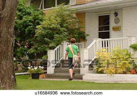 Stock Photograph - Newspaper boy delivering papers, Regina, Saskatchewan. Fotosearch