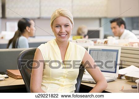 Businesswoman in cubicle smiling View Large Photo Image Stock Image - Businesswoman in cubicle smiling. Fotosearch