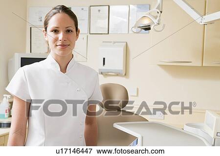 Stock Photo - Dental assistant in exam room smiling. Fotosearch