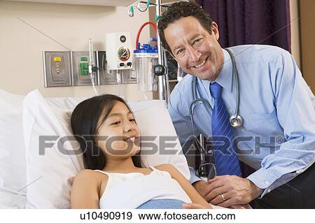 Stock Photo - Doctor Checking Up On Girl. Fotosearch