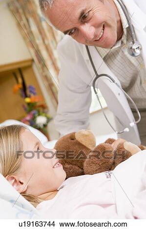 Doctor Checking Up On His Young Patient View Large Photo Image Picture - Doctor Checking Up On His Young Patient. Fotosearch