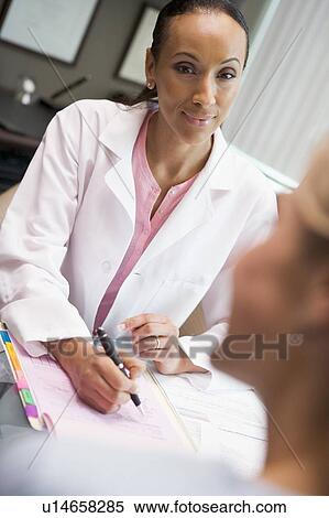 Doctor in consultation with woman at IVF clinic (selective focus) View Large Photo Image Stock Photography - Doctor in consultation with woman at IVF clinic (selective focus). Fotosearch