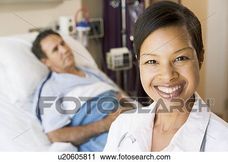 Stock Image - Doctor Smiling In Hospital Room. Fotosearch