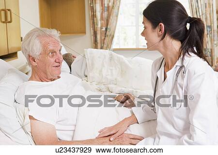Stock Photo - Doctor Talking With Senior Man. Fotosearch