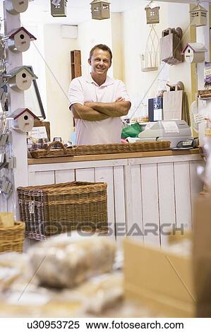 Stock Photography - Man in birdhouse store smiling. Fotosearch