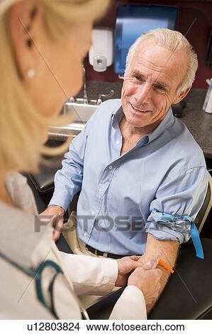 Middle Aged Man Having Blood Test Done View Large Photo Image Picture - Middle Aged Man Having Blood Test Done. Fotosearch