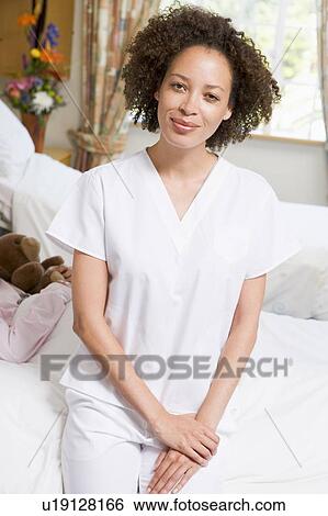 Stock Photograph - Nurse Sitting On Hospital Bed. Fotosearch