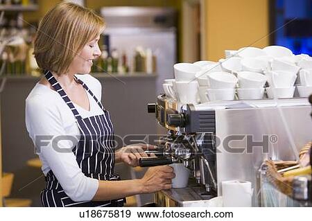 Woman making coffee in restaurant smiling View Large Photo Image Stock Photo - Woman making coffee in restaurant smiling. Fotosearch