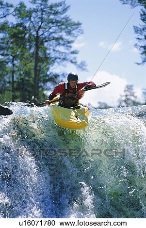 Kayaker in rapids coming over waterfall (selective focus) View Large Photo Image Stock Image - Kayaker in rapids coming over waterfall (selective focus). Fotosearch