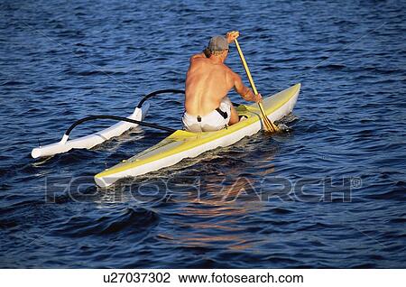 Kayaker outdoors rowing in calm water View Large Photo Image Stock Image - Kayaker outdoors rowing in calm water. Fotosearch