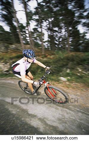 Stock Image - Man outdoors on trails riding bicycle (selective focus). Fotosearch