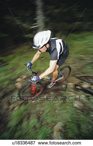 Man outdoors on trails riding bicycle (selective focus) View Large Photo Image Stock Photo - Man outdoors on trails riding bicycle (selective focus). Fotosearch
