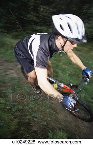Man outdoors on trails riding bicycle (selective focus) View Large Photo Image Stock Photography - Man outdoors on trails riding bicycle (selective focus). Fotosearch