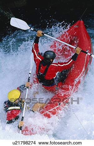 Picture - Two kayakers rowing in rapids (selective focus). Fotosearch