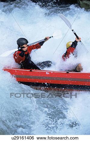 Stock Photograph - Two kayakers rowing in rapids. Fotosearch