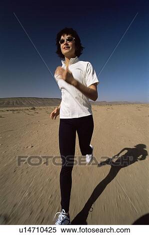 Woman outdoors running on the beach (blur) View Large Photo Image Stock Photography - Woman outdoors running on the beach (blur). Fotosearch