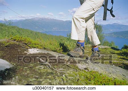 Woman's legs hiking outdoors in scenic location View Large Photo Image Stock Photo - Woman's legs hiking outdoors in scenic location. Fotosearch