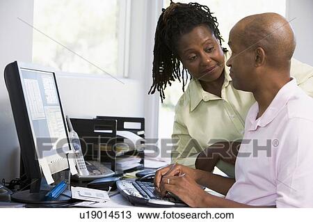 Couple in home office using computer View Large Photo Image Stock Image - Couple in home office using computer. Fotosearch