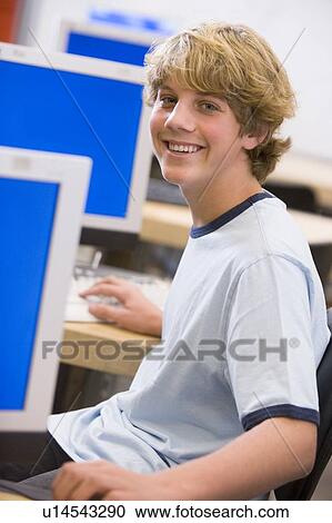 Stock Image - Male student in computer class. Fotosearch