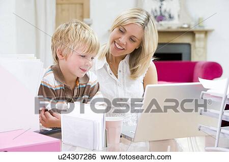 Woman and young boy in home office with laptop smiling View Large Photo Image Stock Photograph - Woman and young boy in home office with laptop smiling. Fotosearch