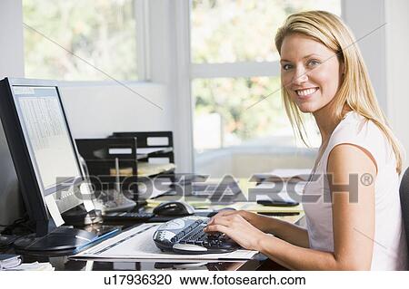 Woman in home office with computer smiling View Large Photo Image Stock Image - Woman in home office with computer smiling. Fotosearch