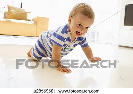 Stock Image - Baby crawling in living room. Fotosearch