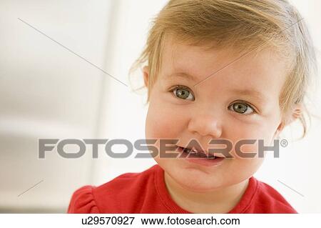 Stock Photo - Baby indoors smiling. Fotosearch