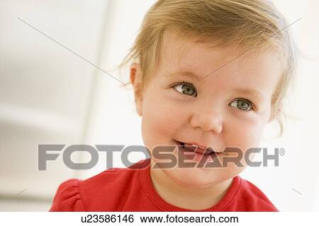 Stock Photograph - Baby indoors smiling. Fotosearch