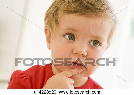 Baby indoors thinking View Large Photo Image Stock Image - Baby indoors thinking. Fotosearch