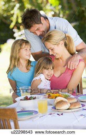 Stock Image - Family Enjoying A Barbeque. Fotosearch
