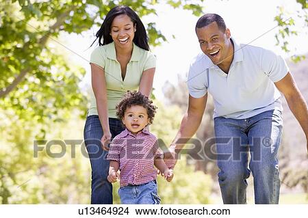 Family running outdoors smiling View Large Photo Image Picture - Family running outdoors smiling. Fotosearch