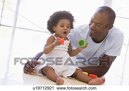 Father and daughter indoors playing and smiling View Large Photo Image Stock Image - Father and daughter indoors playing and smiling. Fotosearch