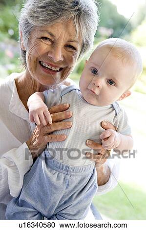 Grandmother outdoors on patio with baby smiling View Large Photo Image Stock Image - Grandmother outdoors on patio with baby smiling. Fotosearch