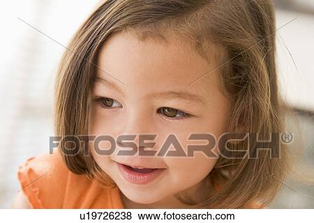 Young girl indoors View Large Photo Image Stock Photo - Young girl indoors. Fotosearch