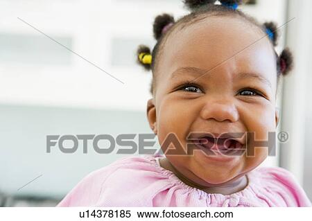Stock Photography - Baby indoors laughing. Fotosearch
