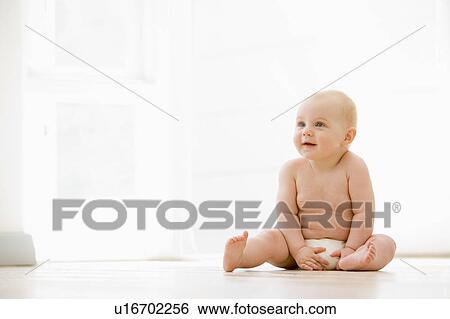 Baby sitting indoors View Large Photo Image Stock Photograph - Baby sitting indoors. Fotosearch