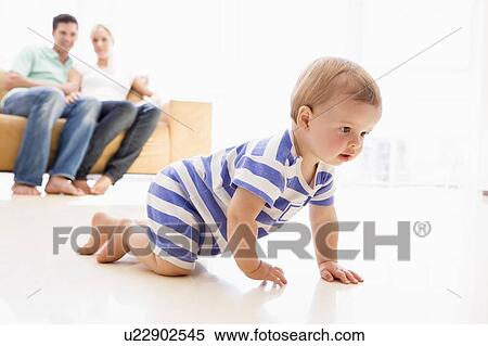 Couple in living room with baby smiling View Large Photo Image Stock Photography - Couple in living room with baby smiling. Fotosearch