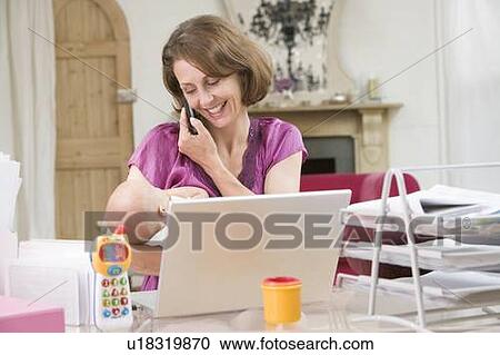 Mother and baby in home office with laptop and telephone View Large Photo Image Stock Image - Mother and baby in home office with laptop and telephone. Fotosearch