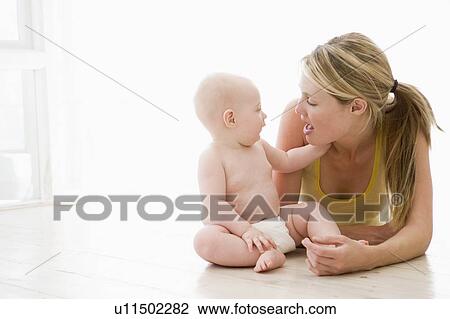 Stock Image - Mother and baby indoors. Fotosearch