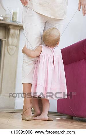 Stock Photo - Mother in living room with baby. Fotosearch