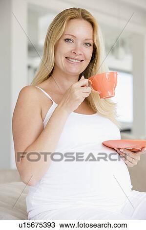 Pregnant woman with cup of tea smiling View Large Photo Image Stock Image - Pregnant woman with cup of tea smiling. Fotosearch