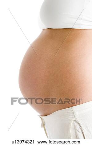 Stock Image - Pregnant woman's exposed belly. Fotosearch