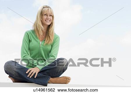 Blonde woman in a green sweater sitting outdoors View Large Photo Image Stock Image - Blonde woman in a green sweater sitting outdoors. Fotosearch