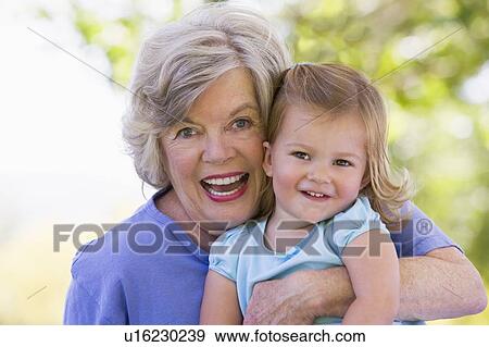 Stock Photo - Grandmother and granddaughter smiling. Fotosearch